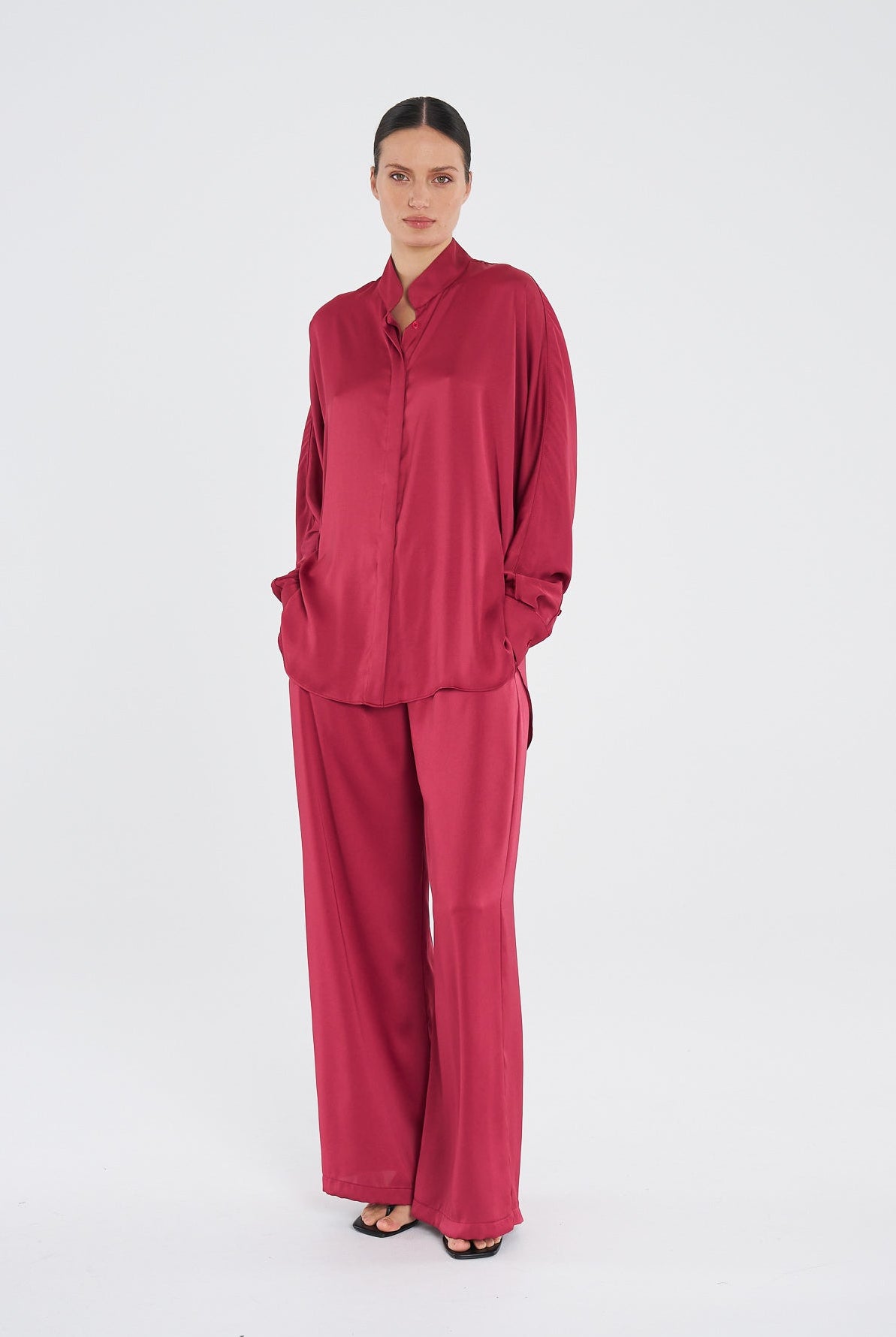 Woman wearing a red outfit on a white background
