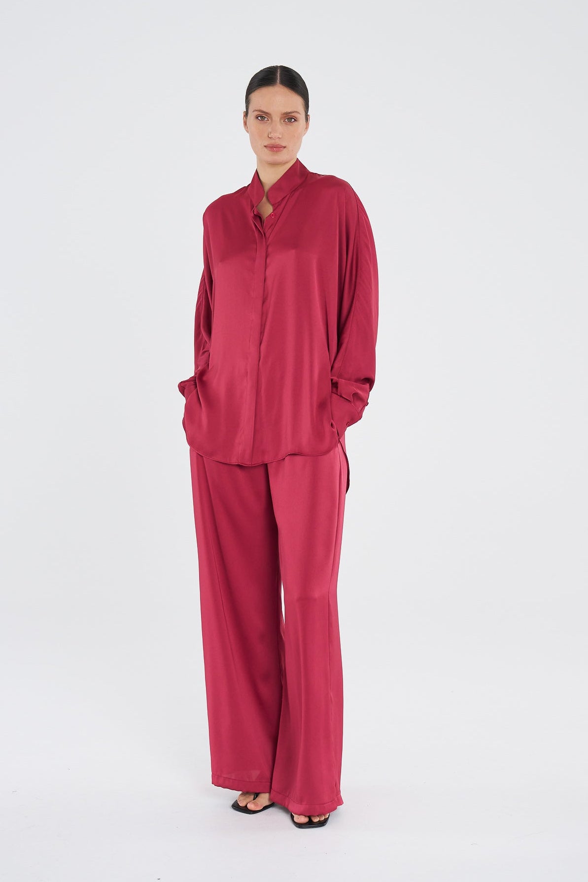 Woman wearing a red outfit on a white background